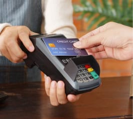 A POS device handles credit card tap, showcasing seamless payment processing.