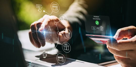 A person uses a laptop for credit card payment via a secure payment gateway.