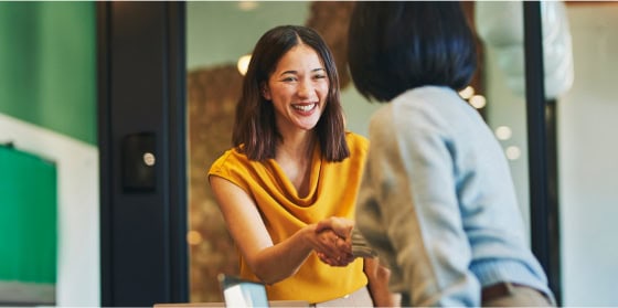 Two women in an office discussing payment gateway and POS system solutions.