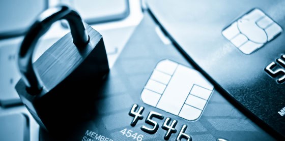 Close-up of credit cards, padlock on keyboard, highlighting POS payment security.