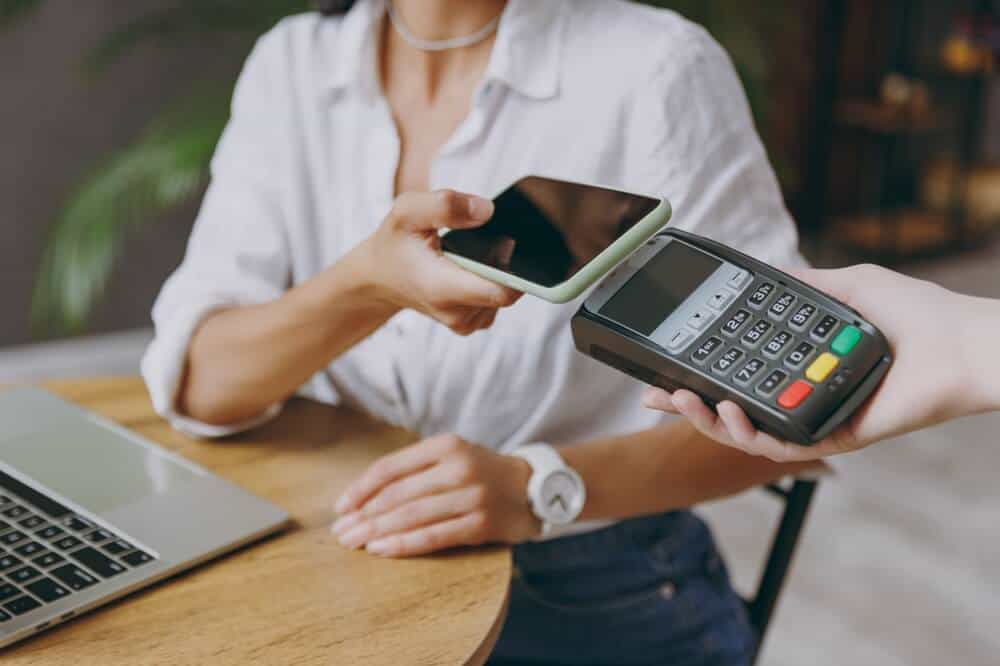 A woman making a payment with a digital wallet