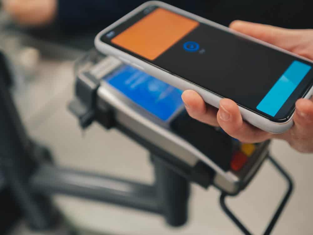 A closeup of a person making a payment using their mobile wallet