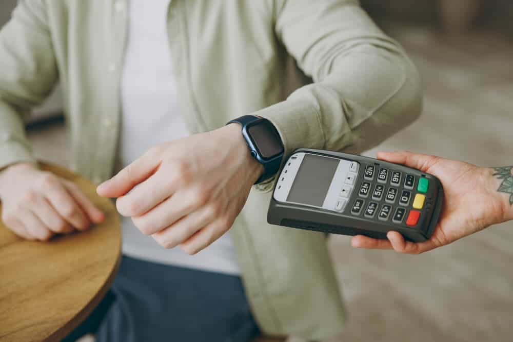 A closeup of a person making a payment using their smart watch.
